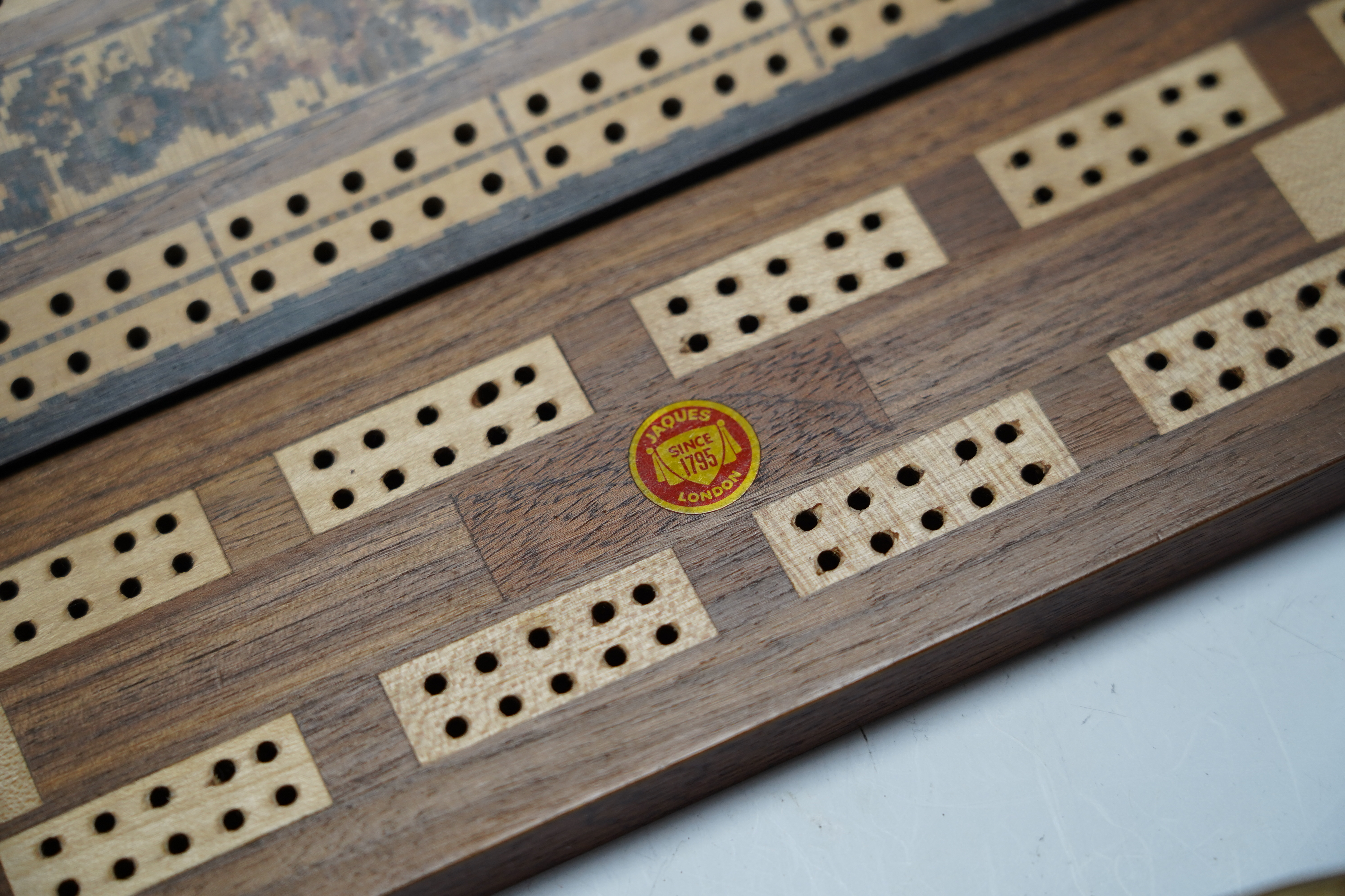 Nine cribbage boards including a horn example, 'Wills Tobacco' advertising and bone and marquetry examples, largest 42cm in length